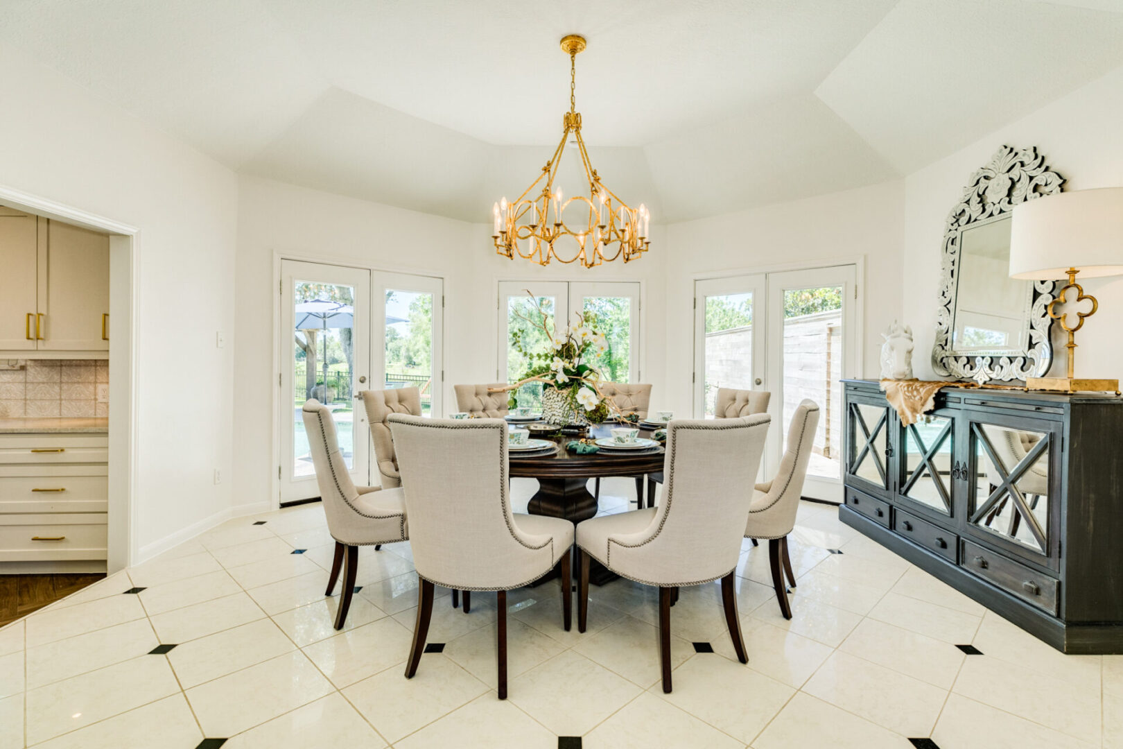 A white dining room with elegant chandelier design.