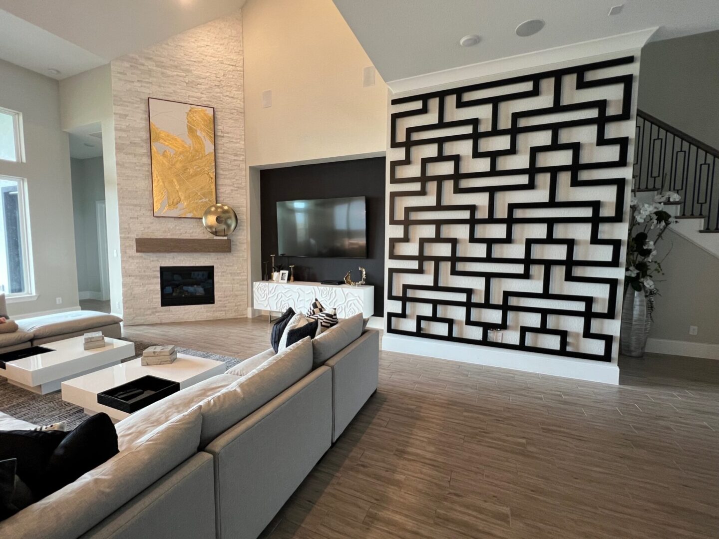 Design a living room with a fireplace and a large wall.