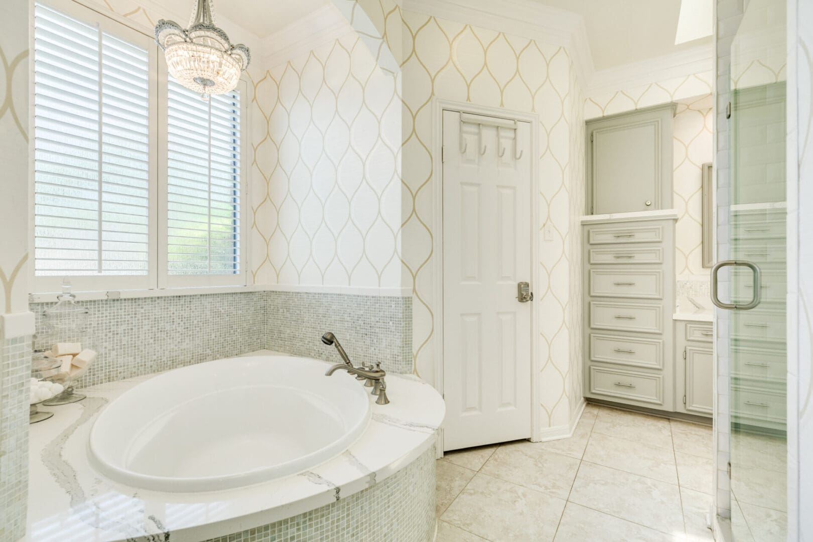 A white bathroom with a tub and shower.