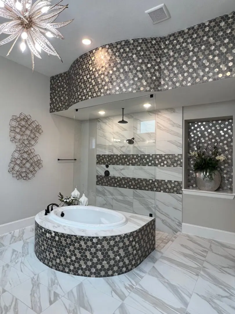 A modern bathroom with a large tub and a chandelier.