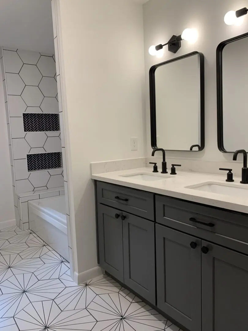 A bathroom with two sinks and a mirror.