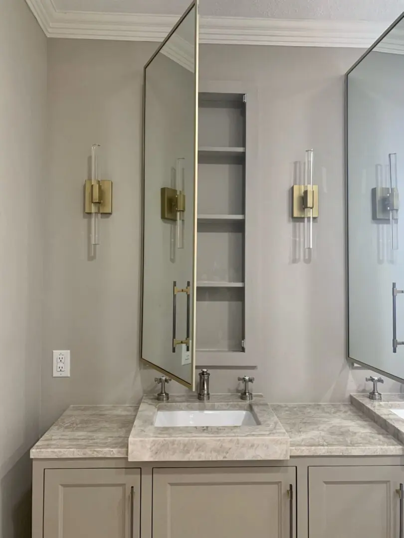 A bathroom with two sinks and a mirror.