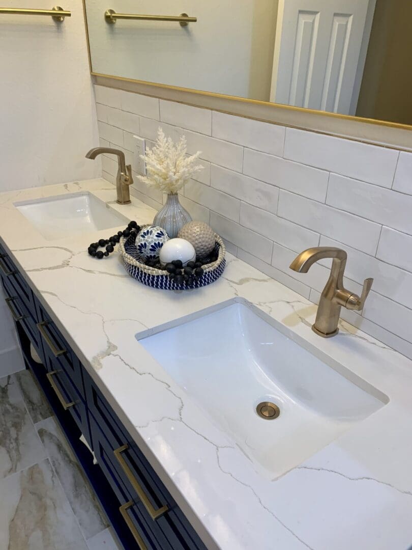 A bathroom with two sinks and a mirror.