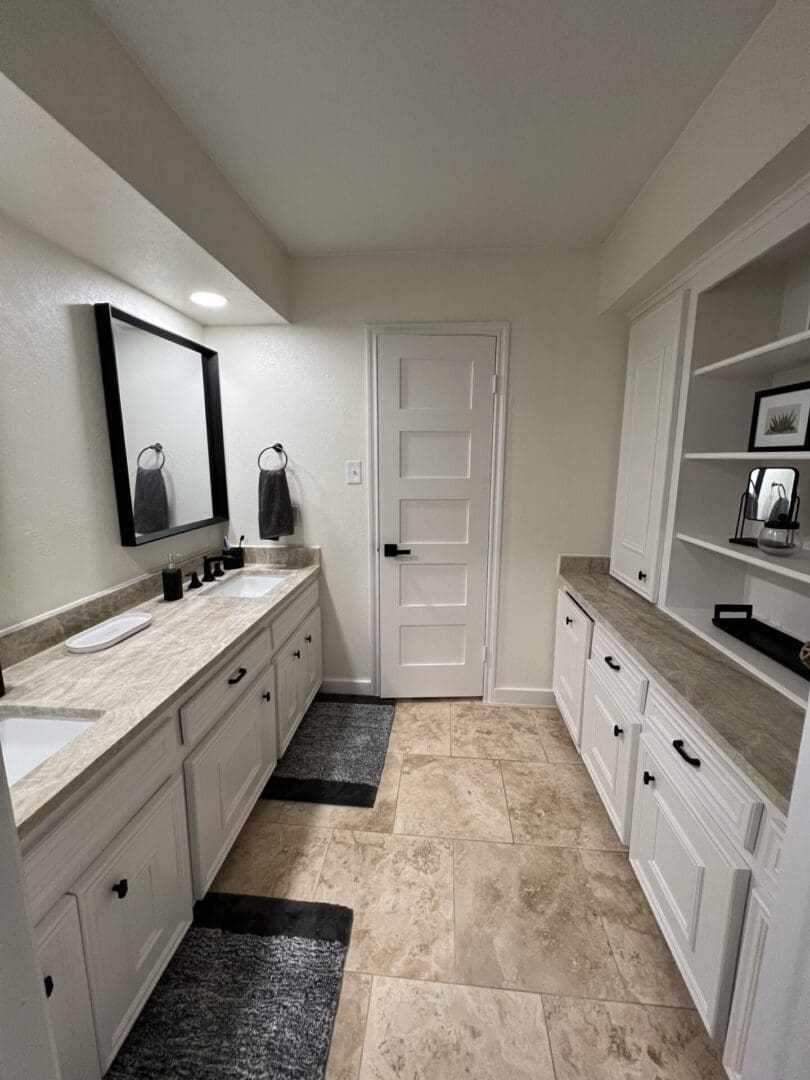 A bathroom with two sinks and a mirror.