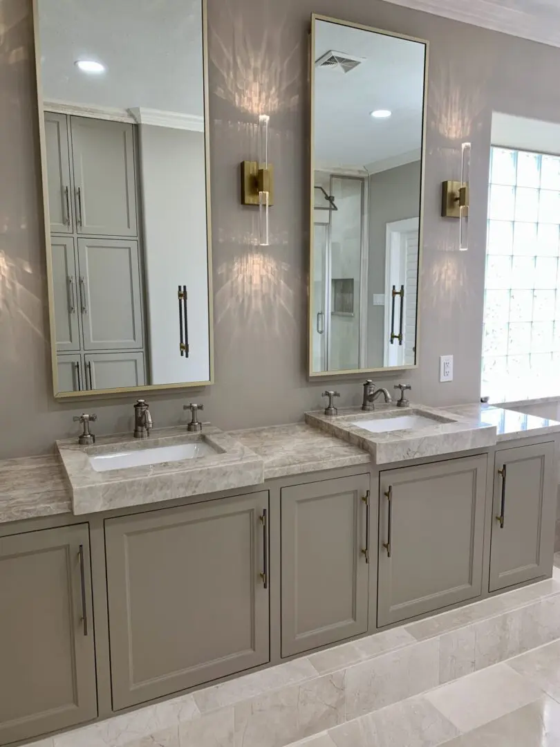 A bathroom with two sinks and mirrors.